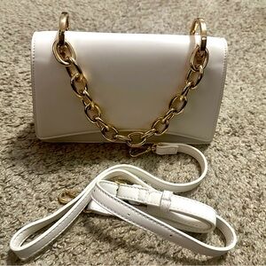 White purse from Aqua. Can be a top handle, clutch or crossbody.
